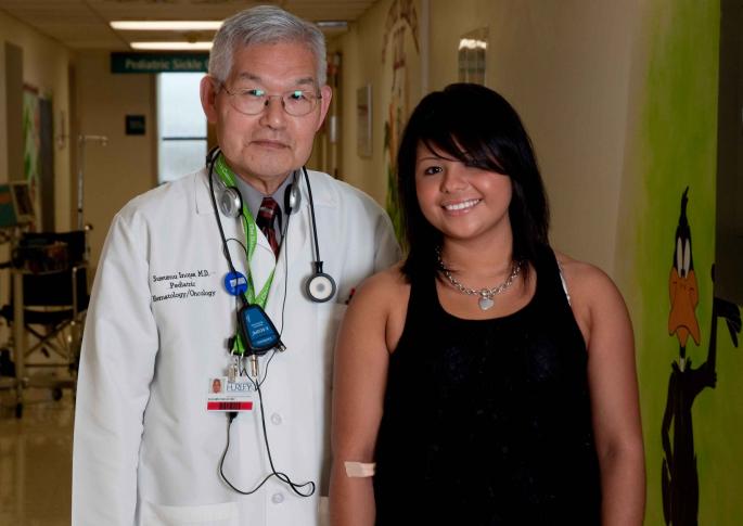 Dr. Inoue and Sabrina Rea pose for a photo in Hurley's Pediatric Oncology Clinic. Rea was diagnosed with cancer at age 6.