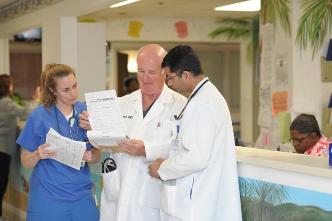 Dr. Nolan talks to 4th-year MSU-FAME medical student Jennifer Simmons 2nd-year Pediatric resident Ramesh Mishra MD in the PICU.