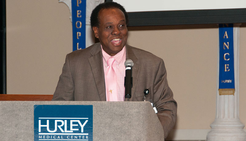 Dr. John Hebert says a few words about each Ob-Gyn resident during Hurley graduation ceremonies in June.